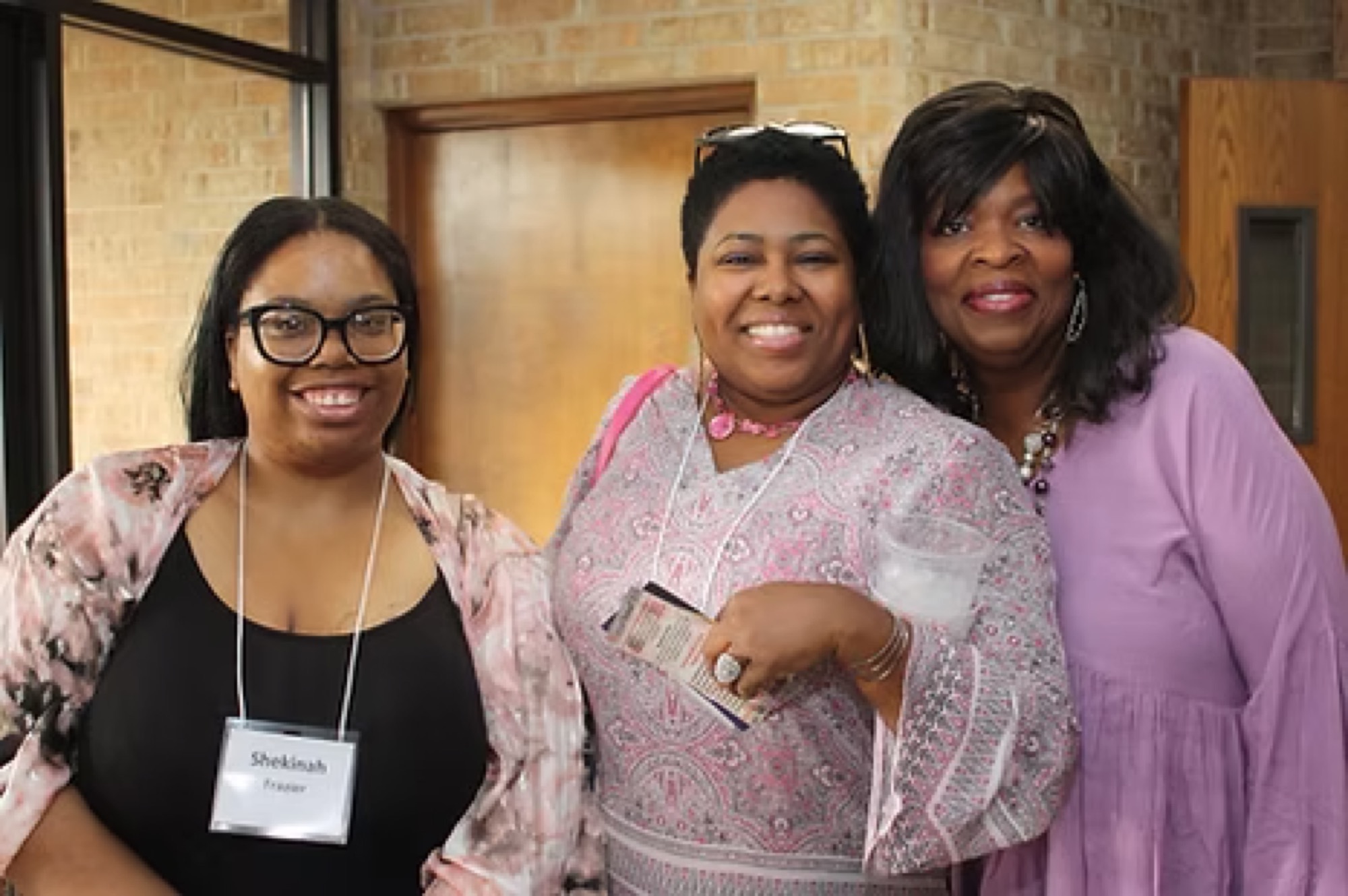 Attendees smiling together at a past Be1 Experience
