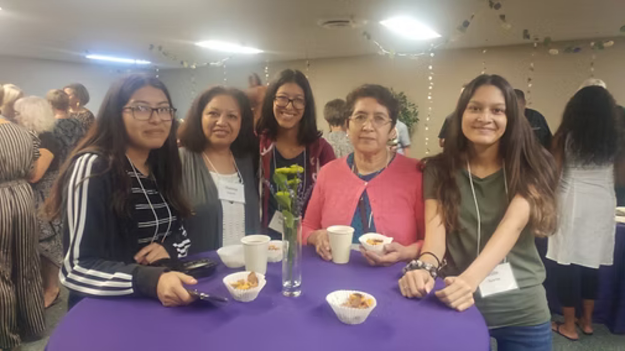 Women gathered around a table at a past Be1 fellowship