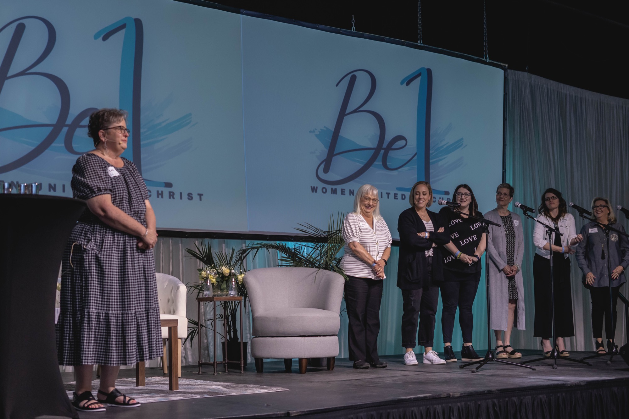 Team introduction on stage at a past Be1 Experience